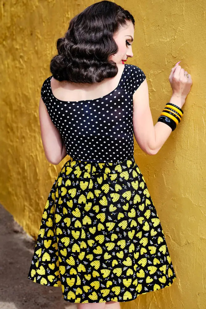 Isabel plus size polka dot sweetheart top featuring a black and yellow bee themed dress with white polka dots on the bodice
