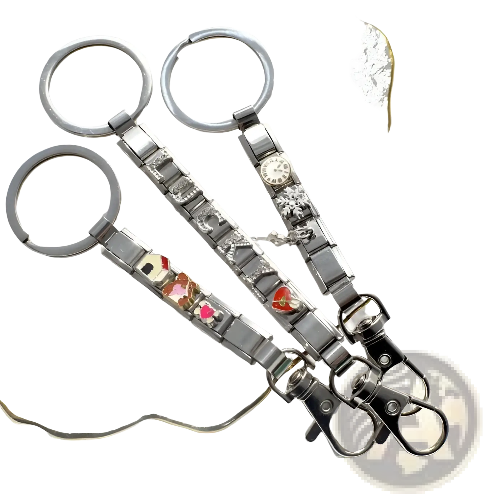 Three silver italian link charm keychains with colorful enamel charms and one featuring a small clock face