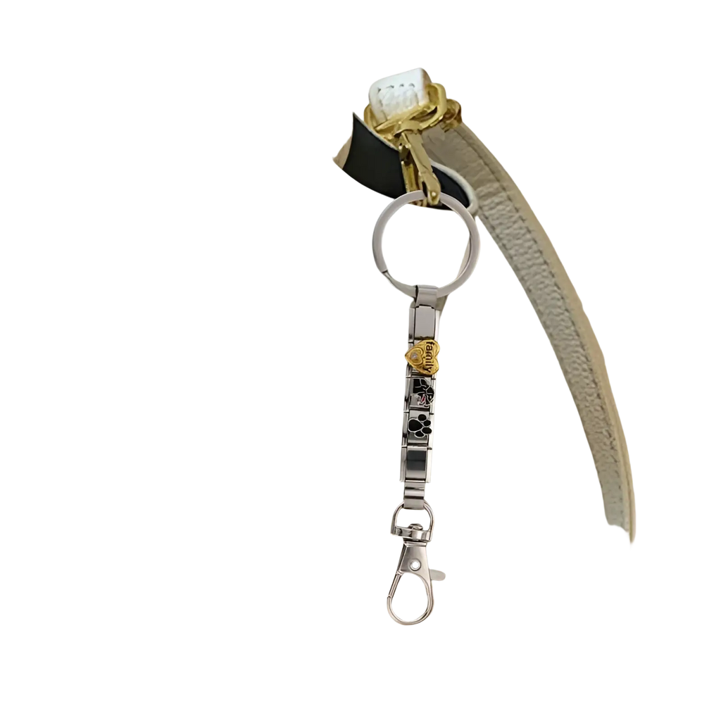 Italian link charm keychain in silver with gold rose charm and black paw print accents on white leather handbag strap