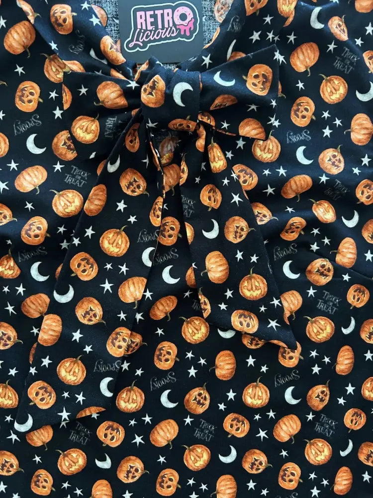 Black cotton apron with orange jack o lanterns white stars and crescent moons printed all over vintage style