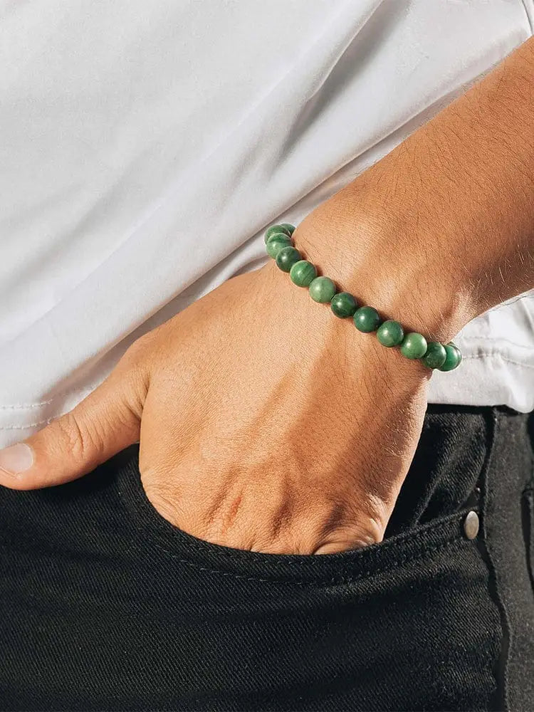 Green jade beaded bracelet with gold stainless steel chain worn on wrist showcasing african jade design
