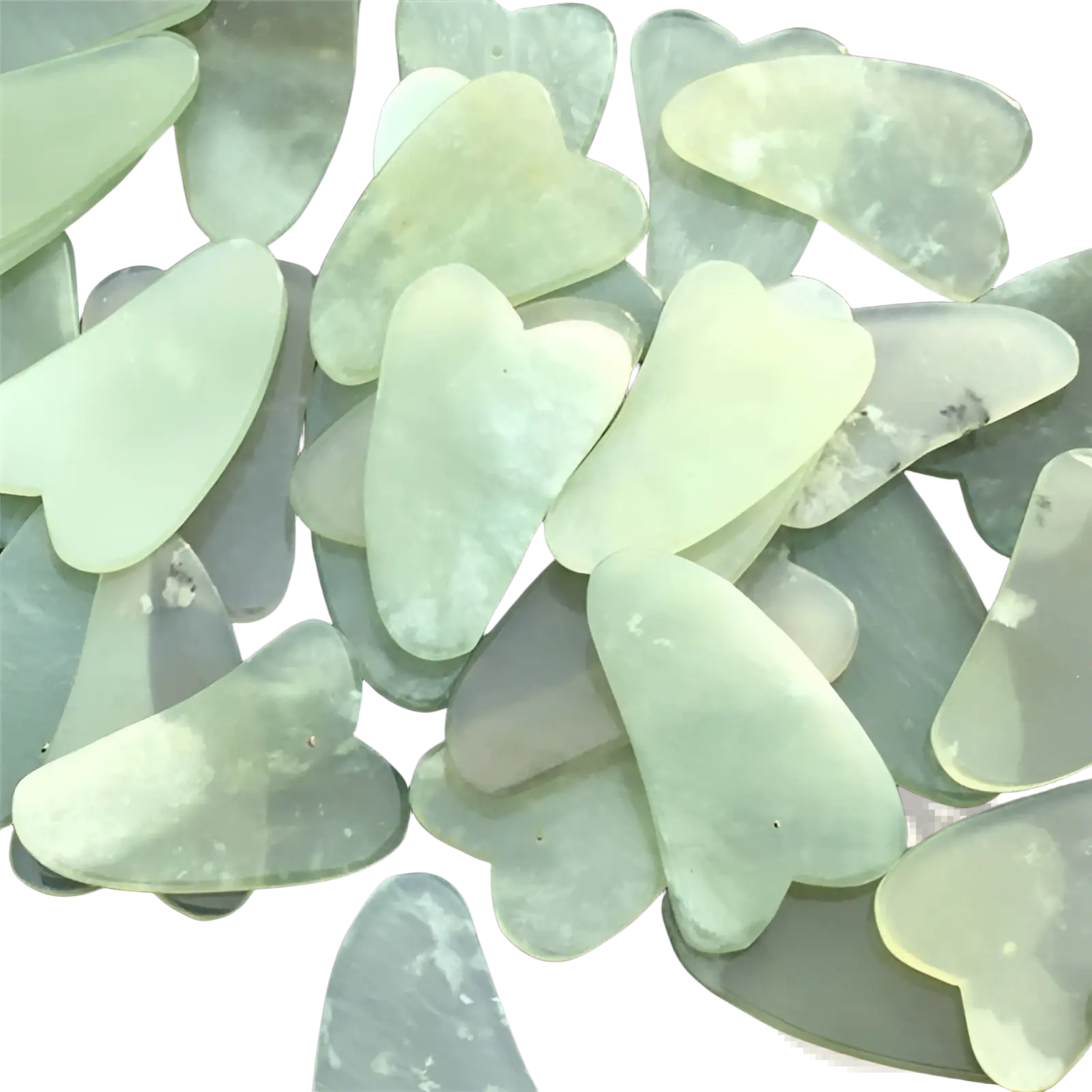 Translucent pale green jade gua sha facial massage tools with heart-shaped designs for skin care use