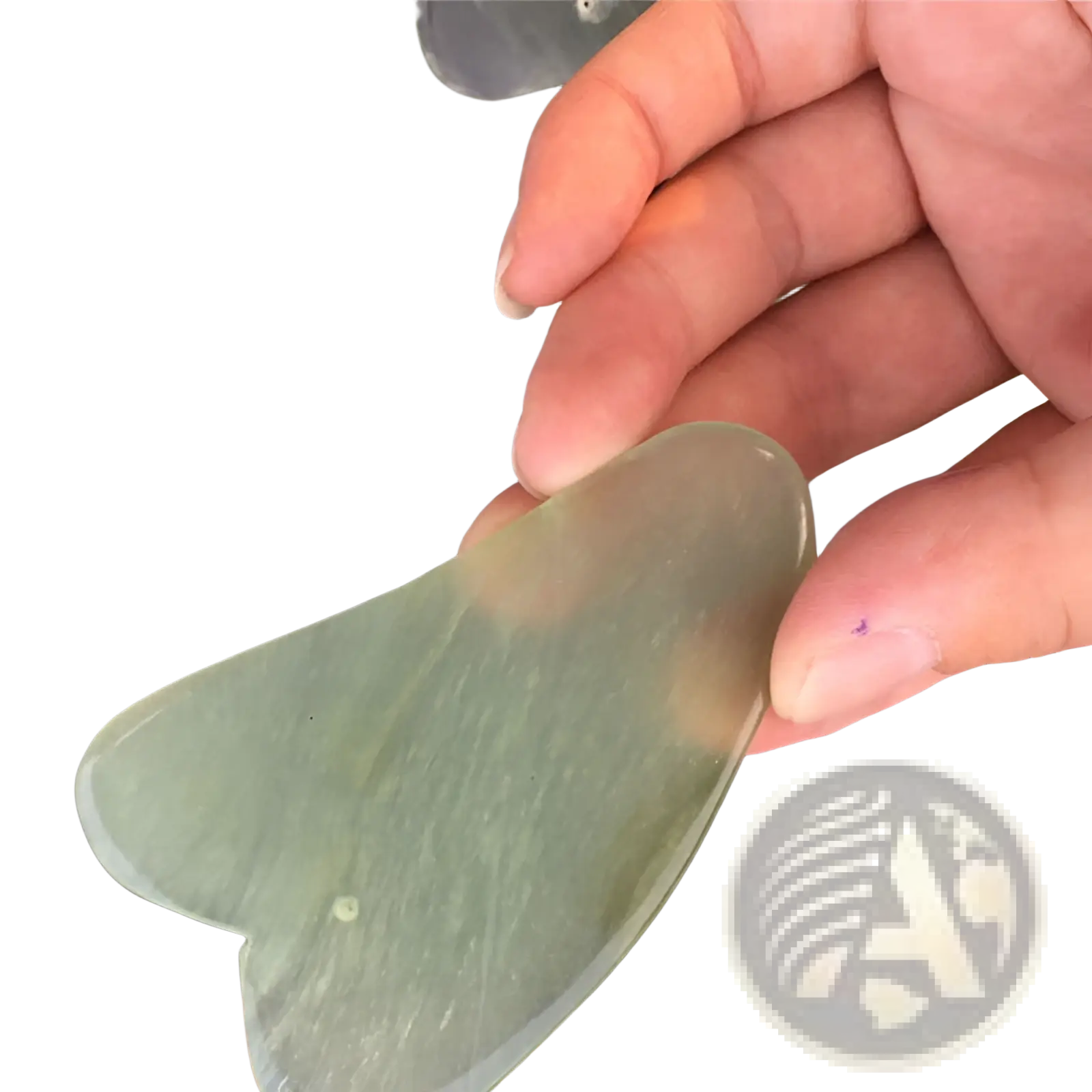 A translucent green jade gua sha facial massage tool with a smooth textured heart-shaped design for skin care