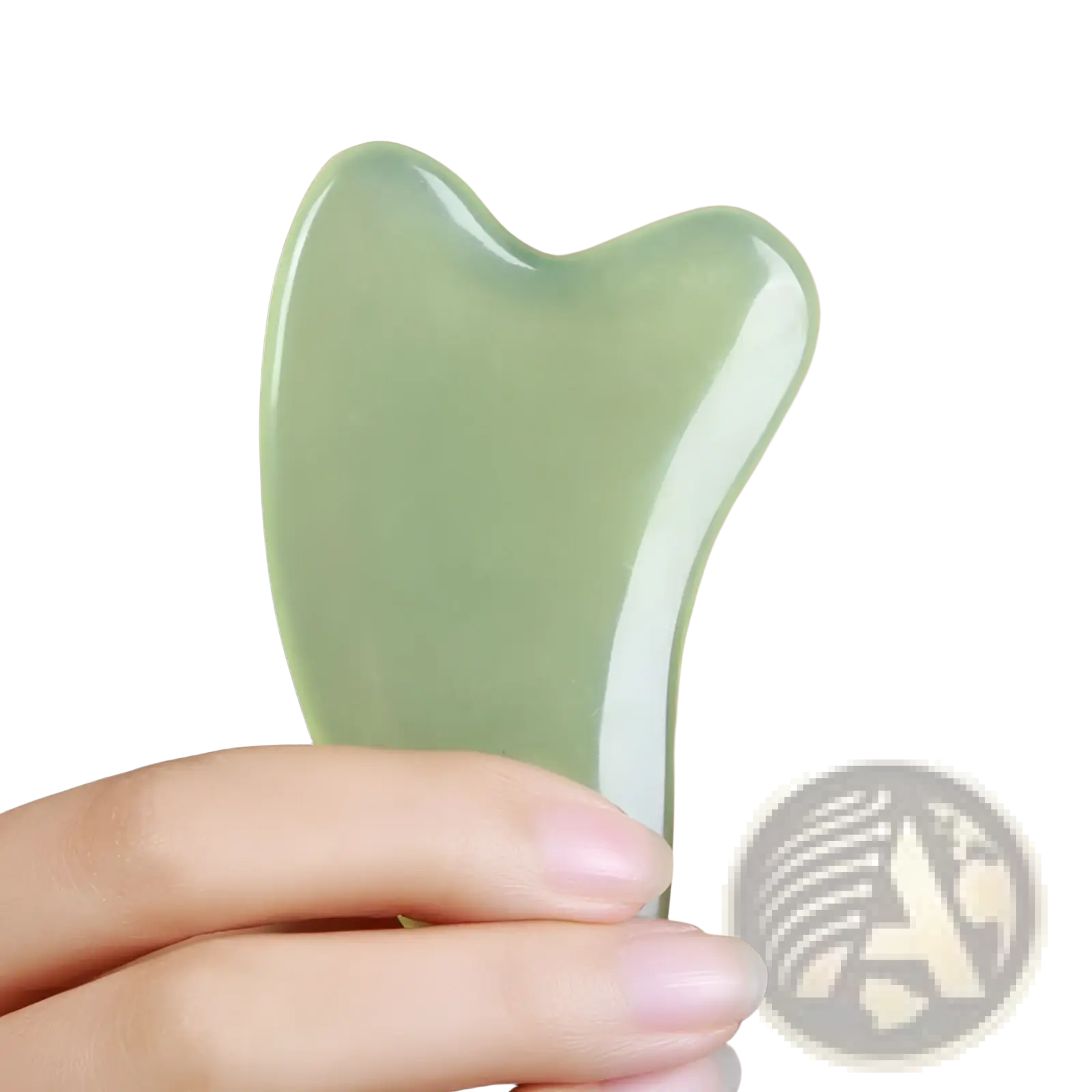 A smooth translucent green jade gua sha facial massage tool with a curved ergonomic shape for skin care