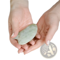 Jade gua sha facial massage tool smooth pale green jade stone with irregular oval shape and natural veining for skin care
