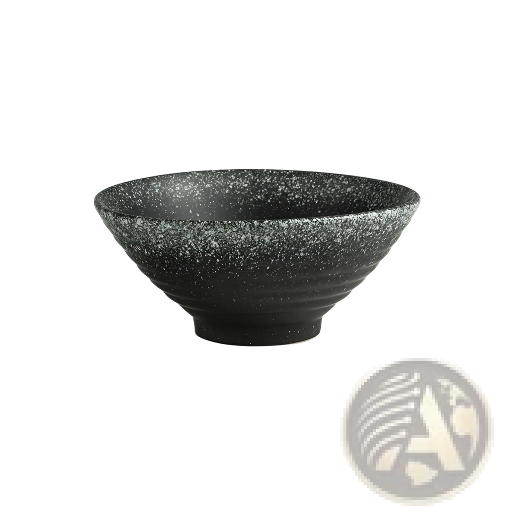 A black speckled ceramic trumpet bowl with ribbed texture and wide shallow rim from Japanese rustic tableware set