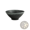 A black speckled ceramic trumpet bowl with ribbed texture and wide shallow rim from Japanese rustic tableware set