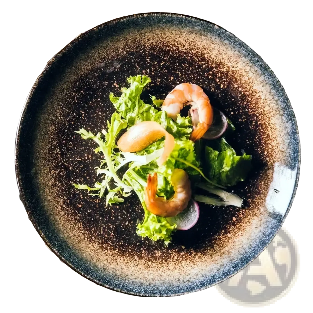 A rustic ceramic Japanese dinner plate with speckled dark brown and gray glaze holding fresh salad and shrimp