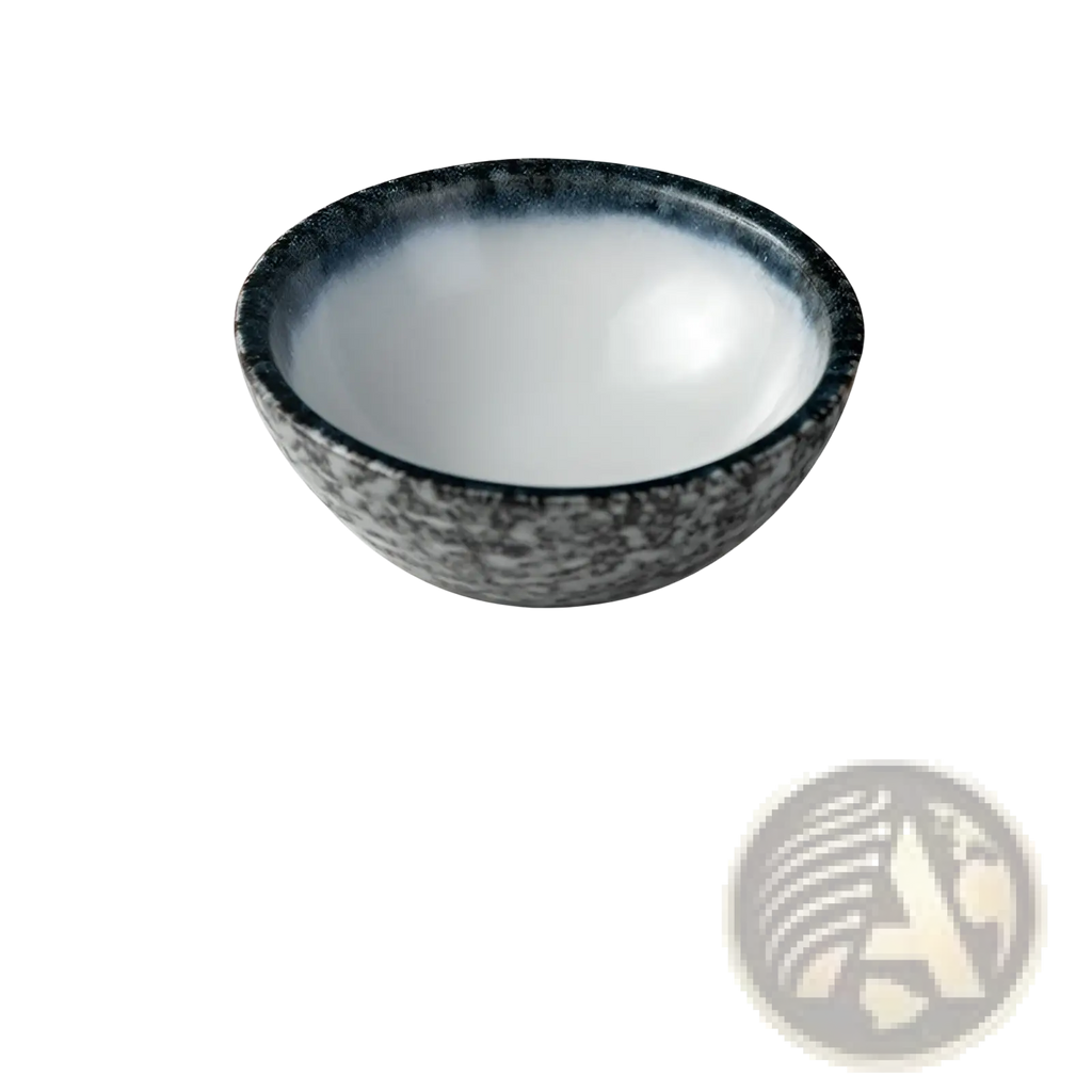 A sleek round ceramic vessel sink with speckled black and gray exterior and smooth white interior for bathroom use