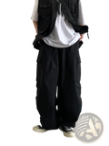 Black Japanese retro loose cargo trousers with multiple pockets and a relaxed wide-leg fit in durable fabric