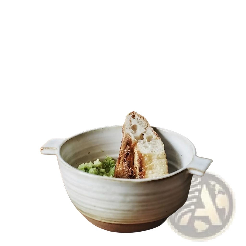 A rustic white japanese stoneware 6 inch binaural ceramic soup bowl with subtle ridges and earthy glazed finish