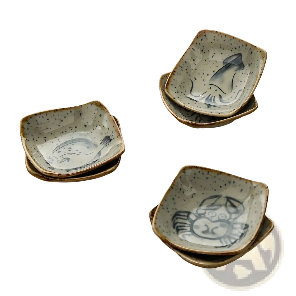 Set of three square ceramic sauce dishes with speckled glaze and hand-painted seafood motifs in Japanese style