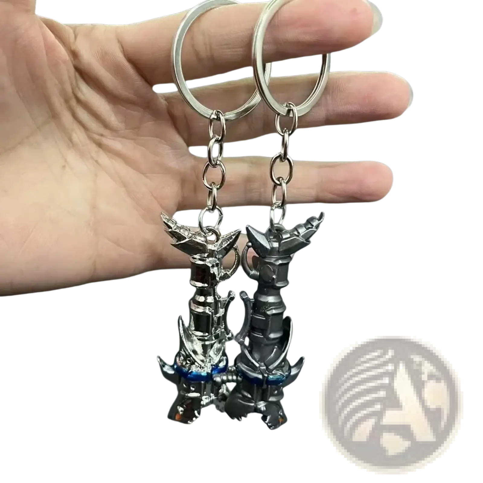 Two metallic jinx cannon anime keychains featuring detailed dark gray and silver robotic figures with blue accents