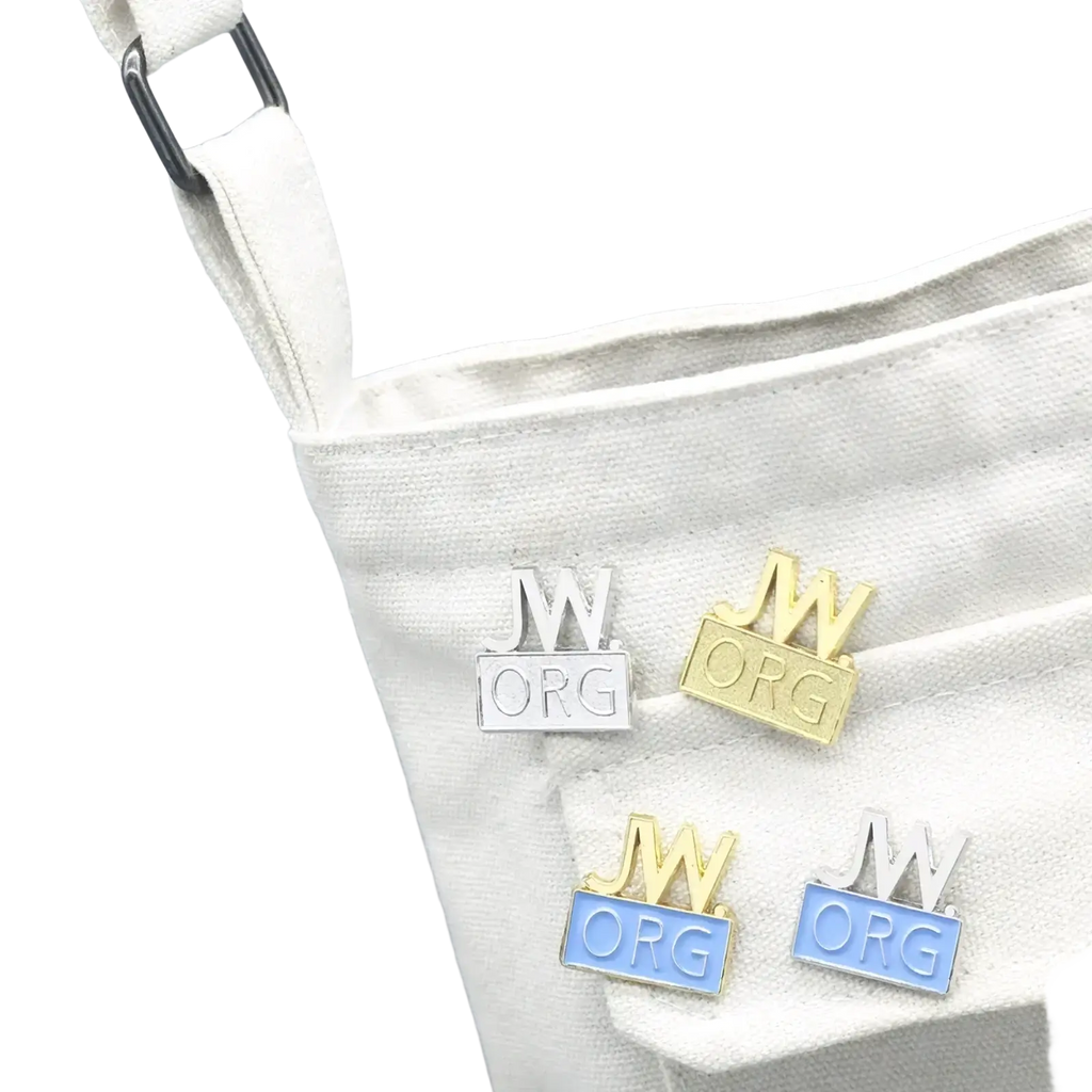 Silver and gold enamel brooch pin set featuring jw org logo with crown design displayed on white canvas bag