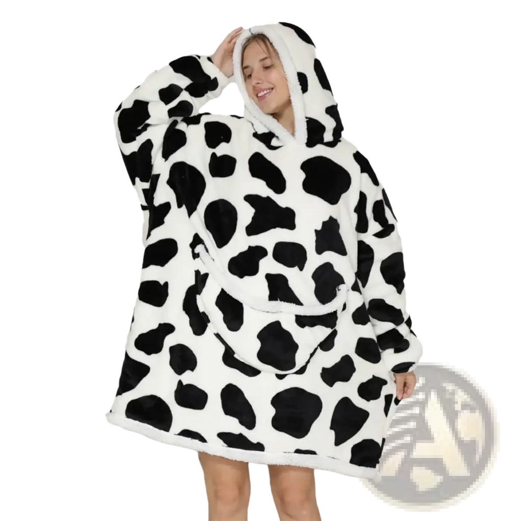 A cozy white and black cow-print oversized sherpa fleece blanket hoodie with plush hooded design