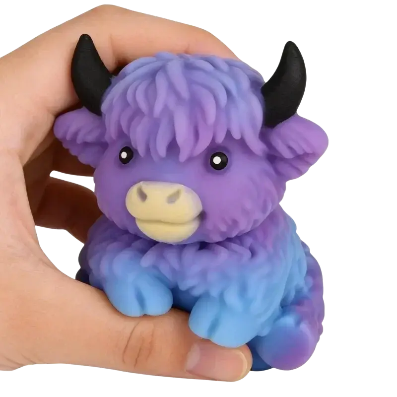Kawaii Highland Cow squishy stress relief toy in purple and blue gradient fuzzy texture with black horns and yellow nose