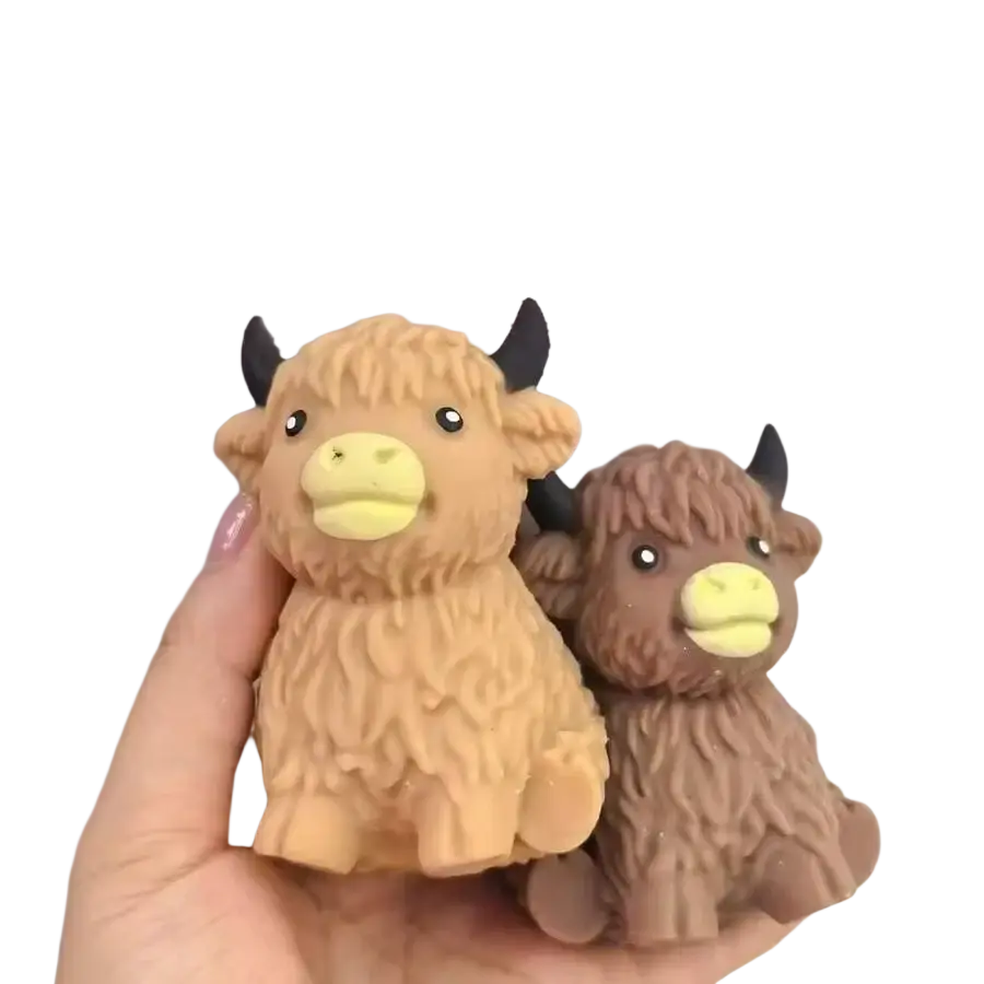 Two plush textured kawaii highland cow squishy stress relief toys in tan and brown with black horns and yellow snouts