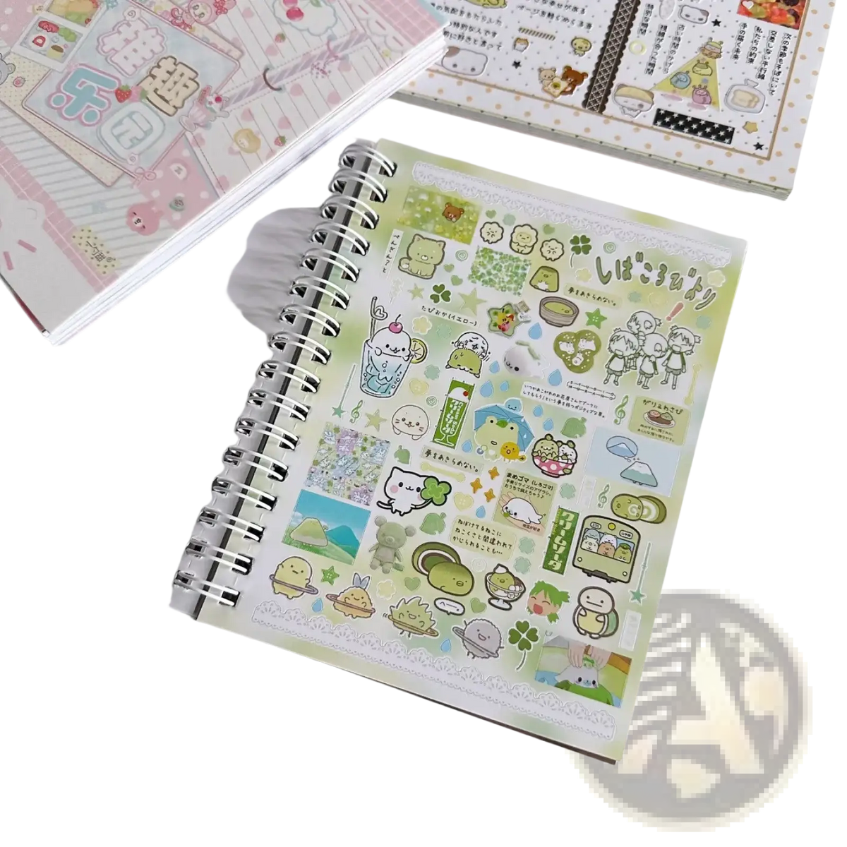 A spiral-bound notebook with a light green cover featuring kawaii kpop stickers for journaling and stationery use