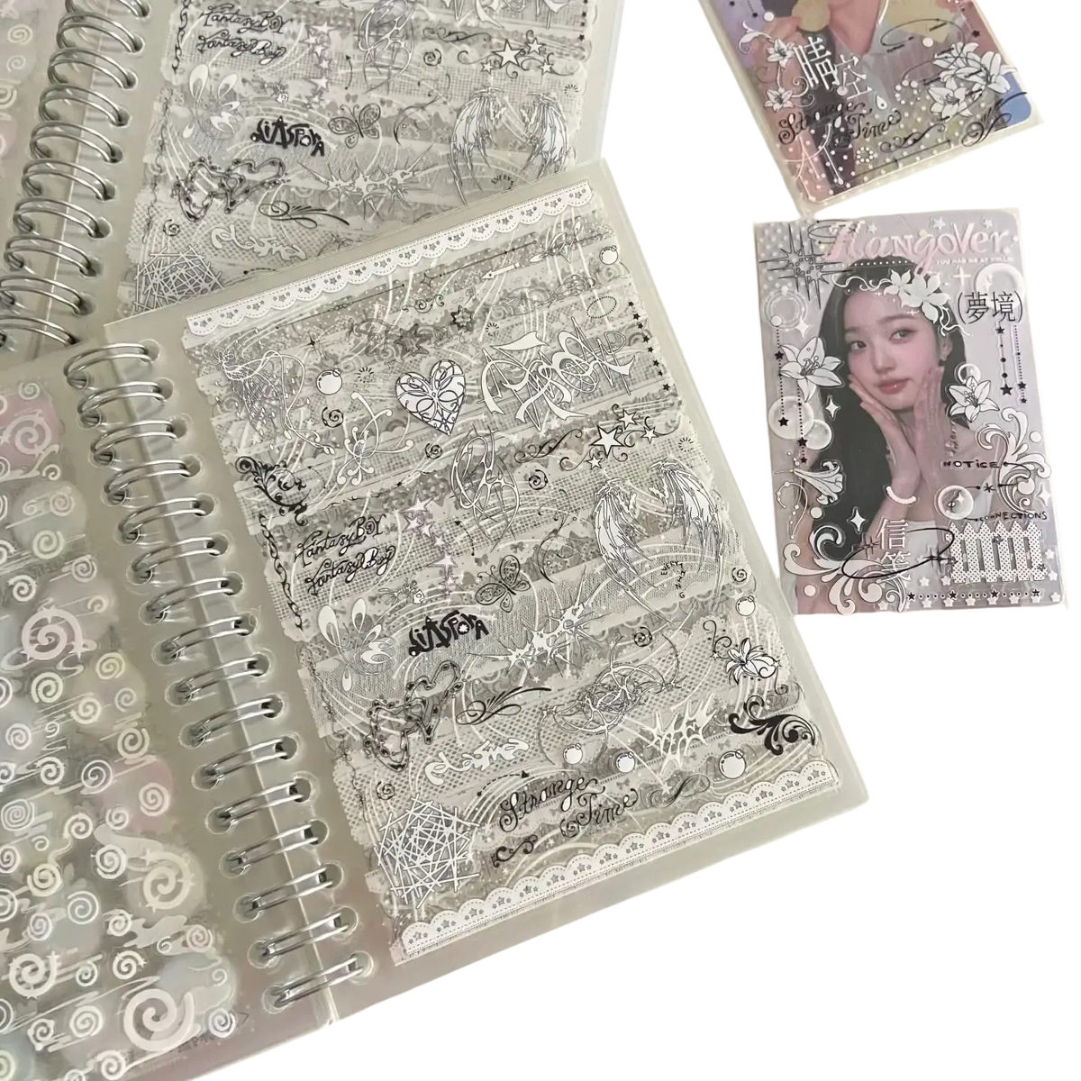 Clear plastic kawaii kpop sticker book spiral journal with black and white doodles hearts stars swirls lace trim design