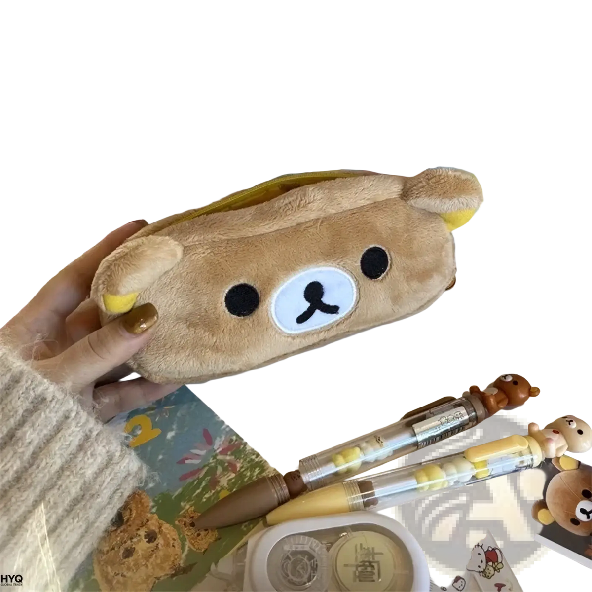 A soft tan plush pencil case shaped like rilakkuma with black button eyes and a white nose patch