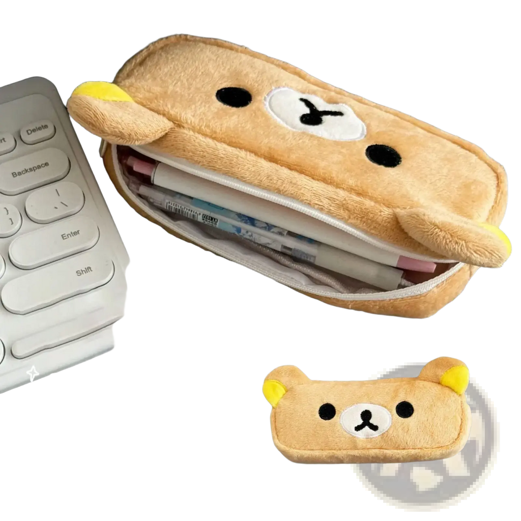 A kawaii rilakkuma plush pencil case in tan color with soft fur texture and embroidered black eyes and white nose