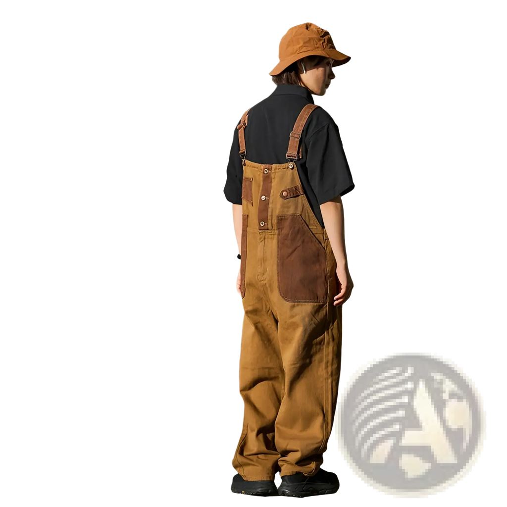 Khaki retro suspender overalls in tan corduroy with brown leather patches and straps showing the back side
