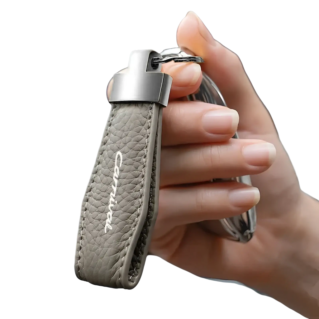 Gray leather Kia Carnival keychain with silver clasp and carnival embroidered in white thread for car key ring holder