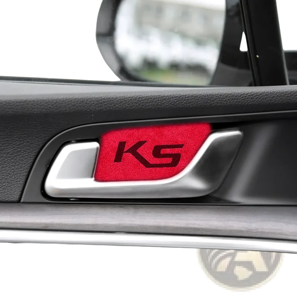 Red textured ks emblem sticker on silver kia k5 suede carbon interior door handle cover visible from front side