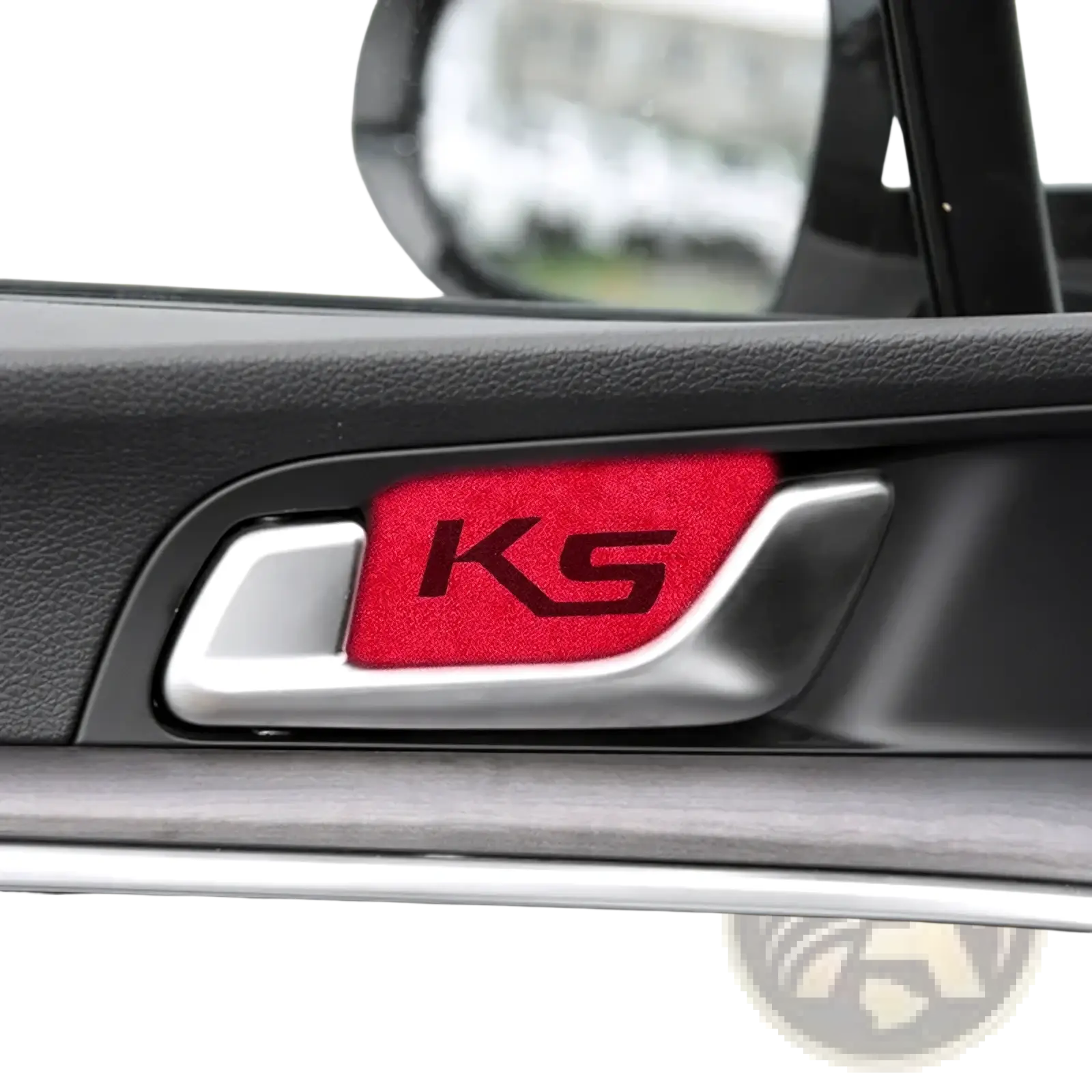 Red textured ks emblem sticker on silver kia k5 suede carbon interior door handle cover visible from front side