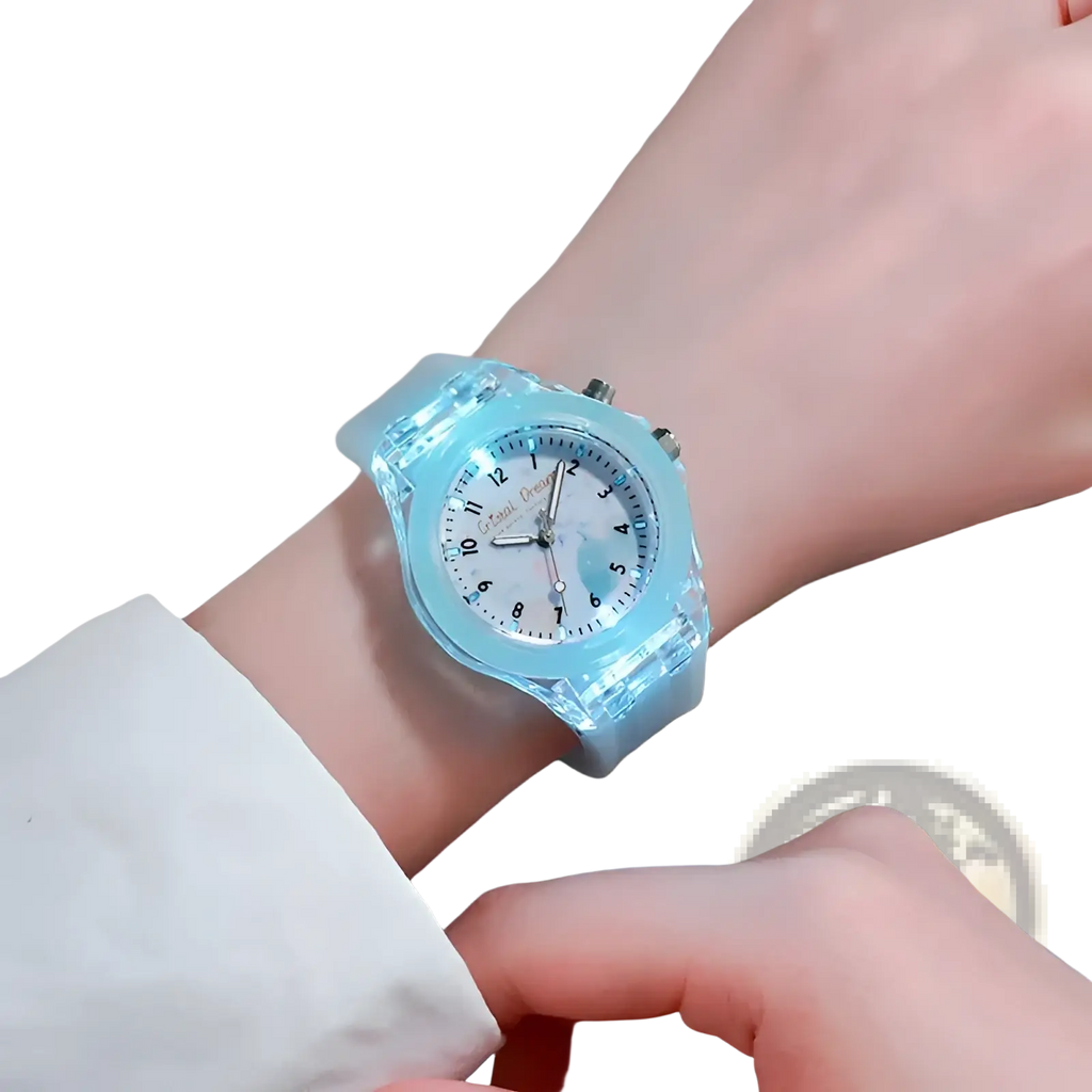 Kids glowing led silicone sports watch with a translucent light blue plastic band and a glowing face with silver hands