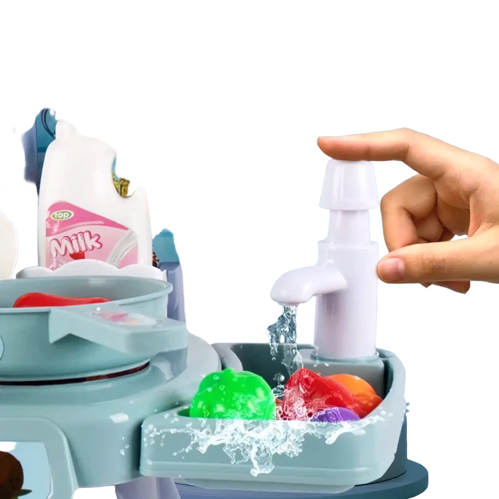 White plastic toy faucet with push-button feature dispensing water onto colorful play food in kids kitchen play set with lights and sounds