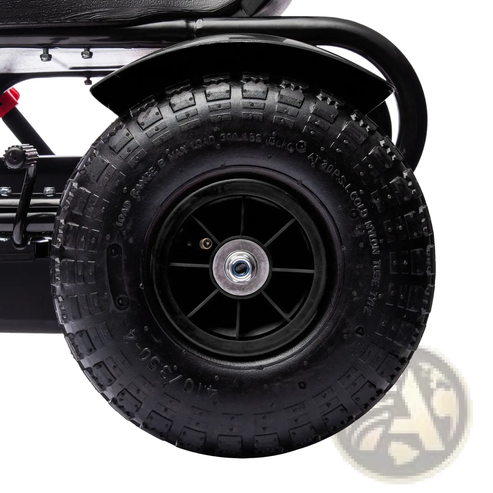Black rubber tire with deep treads mounted on a black wheel hub with silver center cap on kids pedal go kart toy