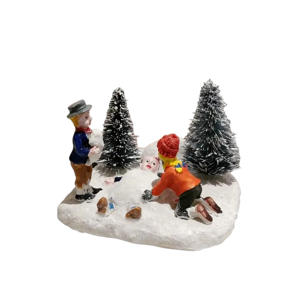 Kids playing snow christmas village figurine set with two children and snowman in snowy terrain with frosted pine trees