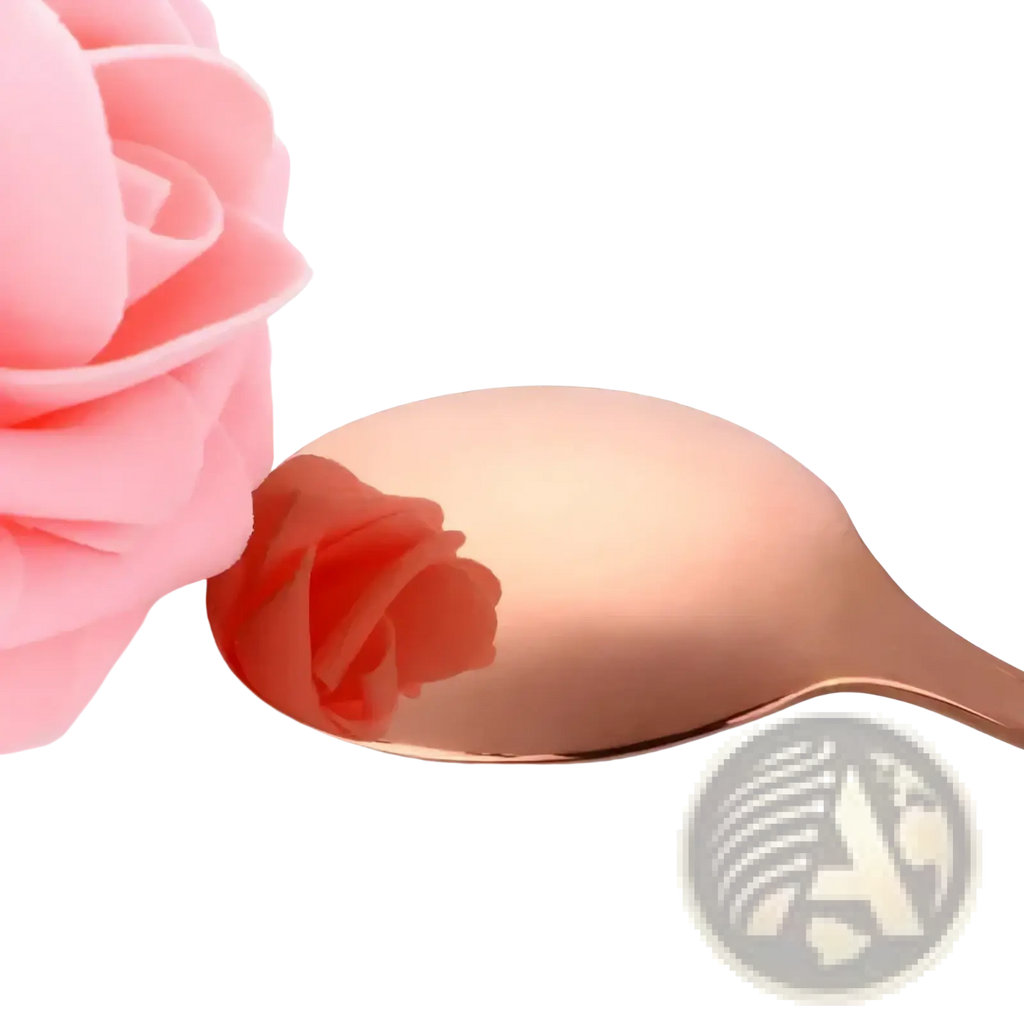 A rose gold stainless steel spoon with a smooth reflective surface from a kids flatware set
