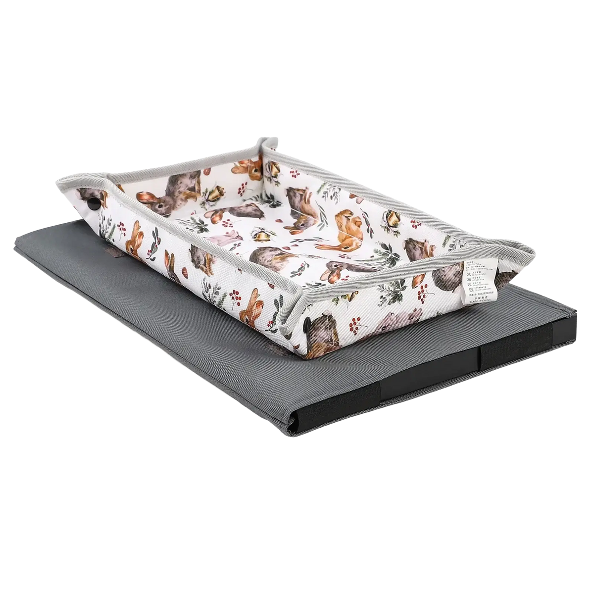 Insular baby changing pad with white fabric featuring brown and gray rabbits and grey ribbed trim for travel use