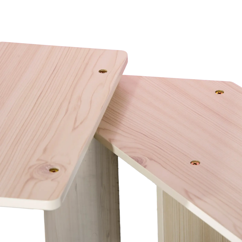Light-colored wooden desk panels with visible grain and gold-toned screws on kids wooden kitchen playset with sound effects
