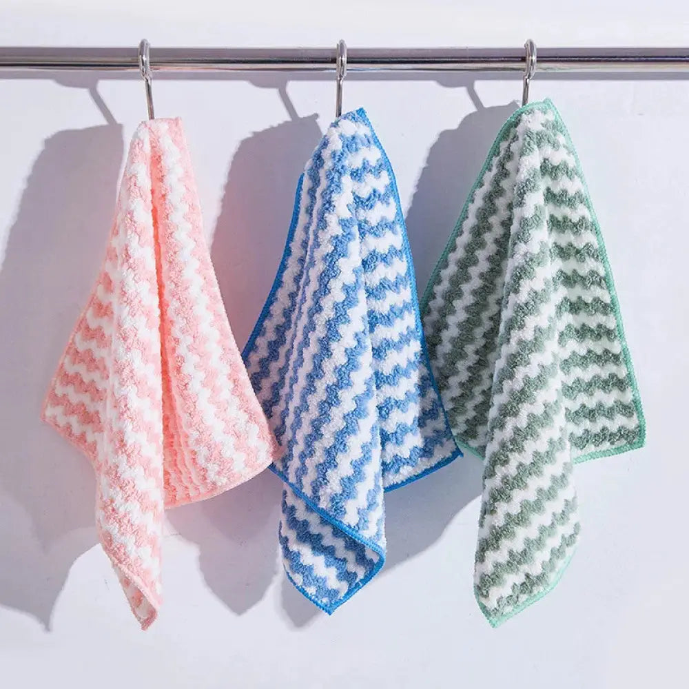 Three soft textured microfiber super absorbent striped coral fleece kitchen cleaning cloths in pink blue and green hang on rod