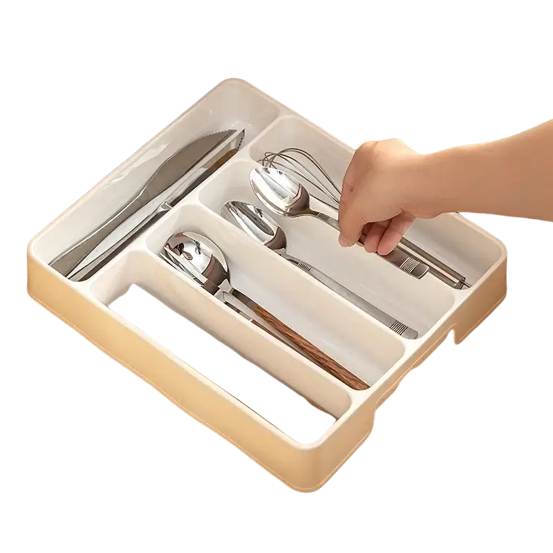 Beige plastic kitchen drawer adjustable utensil organizer tray with segmented compartments holding silverware and chopsticks