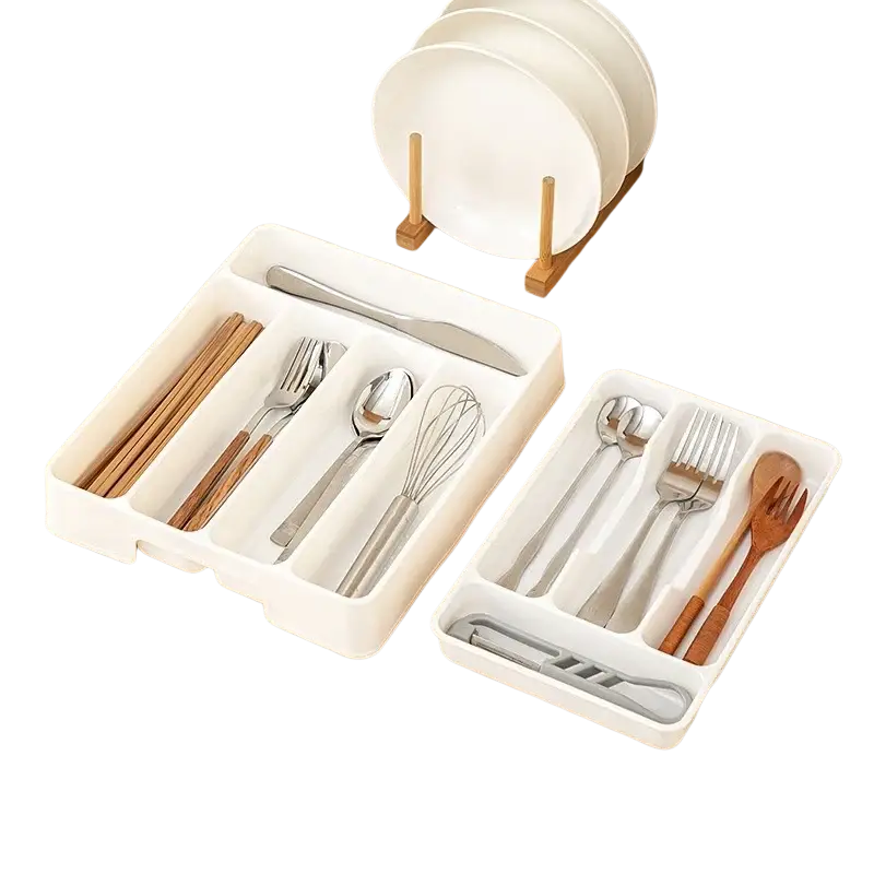 White plastic kitchen drawer adjustable utensil organizer tray with segmented compartments holding cutlery