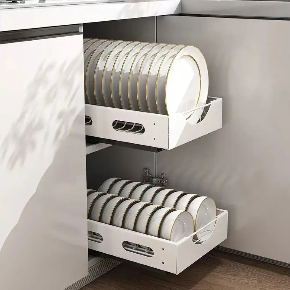 Adjustable white kitchen drawer dividers made of pull-out organizer holding stacked plates with gold rims