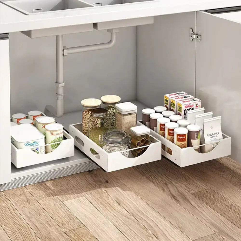 Adjustable white kitchen drawer dividers with pull-out trays and integrated handles for organizing pantry jars and boxes