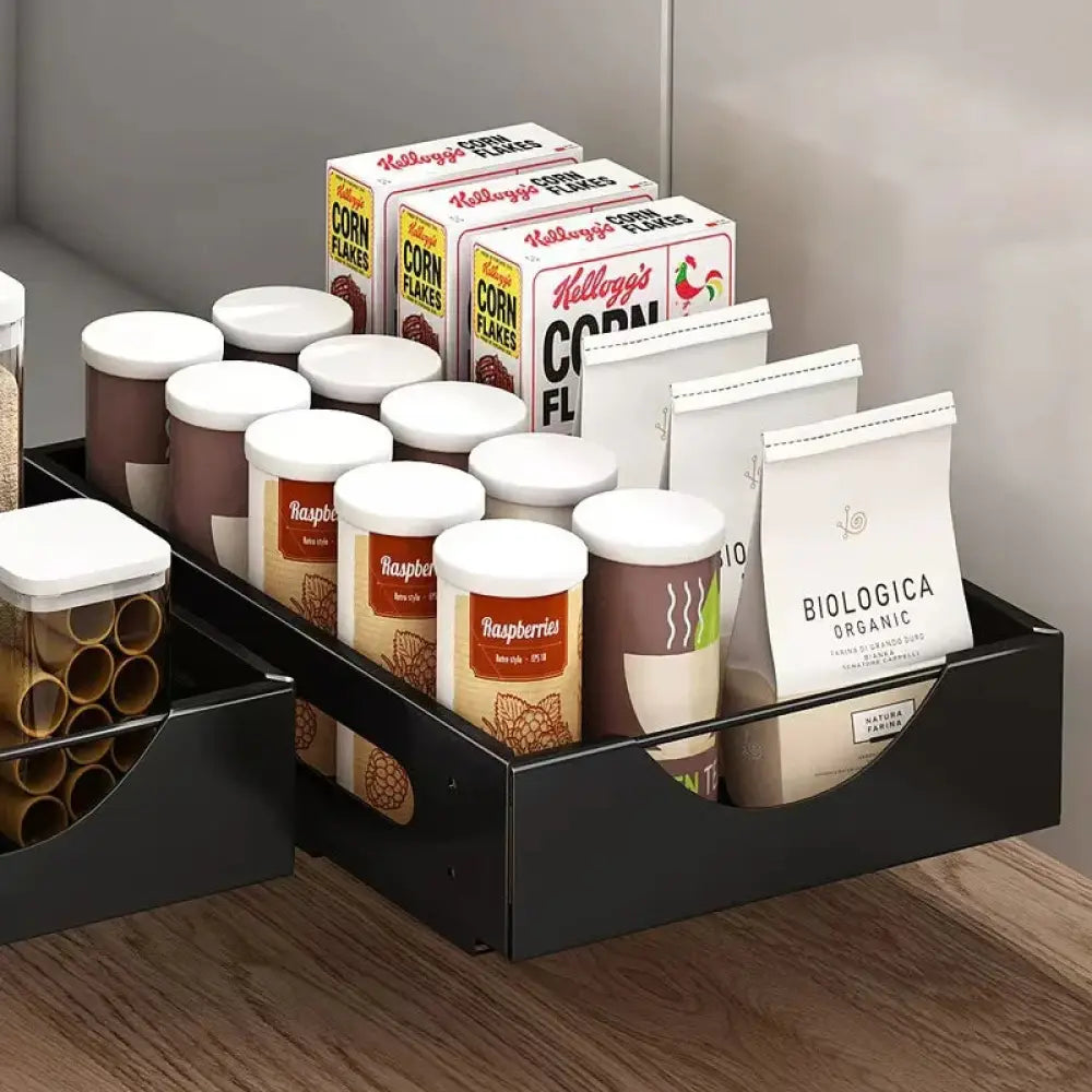 Black plastic pull-out kitchen organizer holding food containers complementing adjustable white kitchen drawer dividers