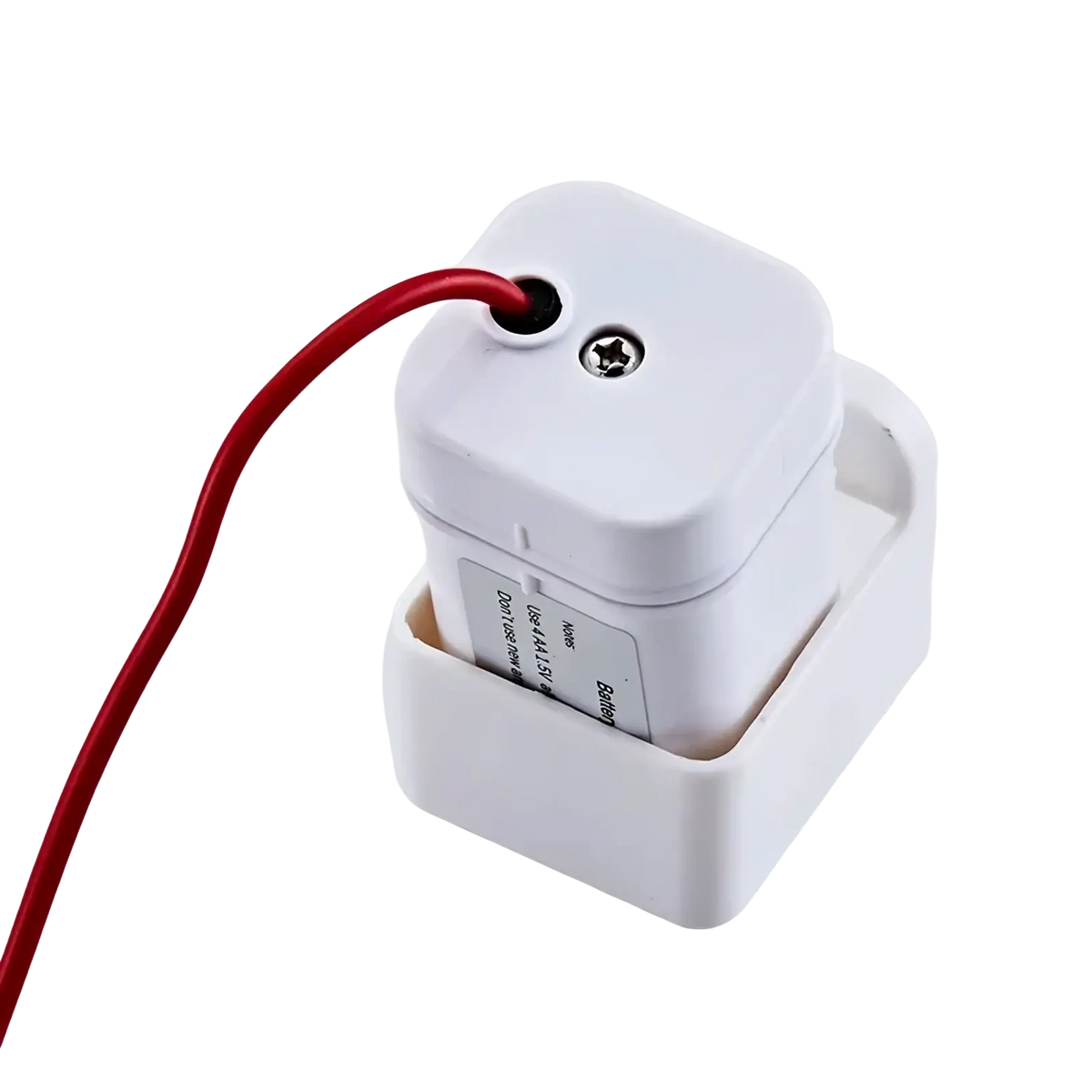 White plastic wall-mounted electrical outlet cover with red cord plugged into top port for kitchen faucet sensor battery box