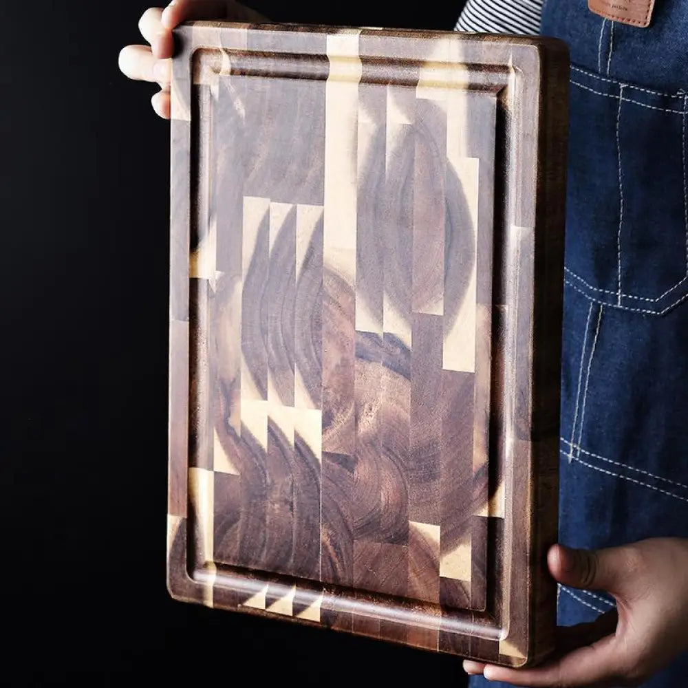 Rectangular striped parquet solid wood cutting board with a mosaic pattern of dark and light wood pieces