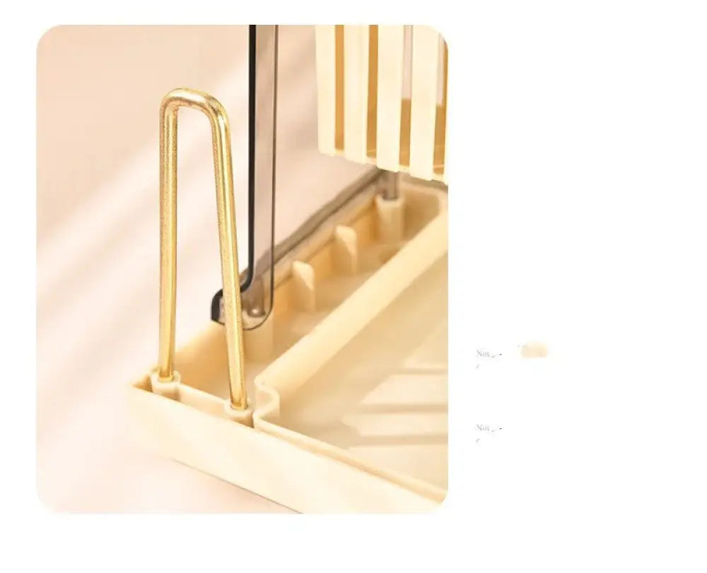 Cream acrylic knife block with gold-colored metal handle attached to beige plastic base with vertical slats