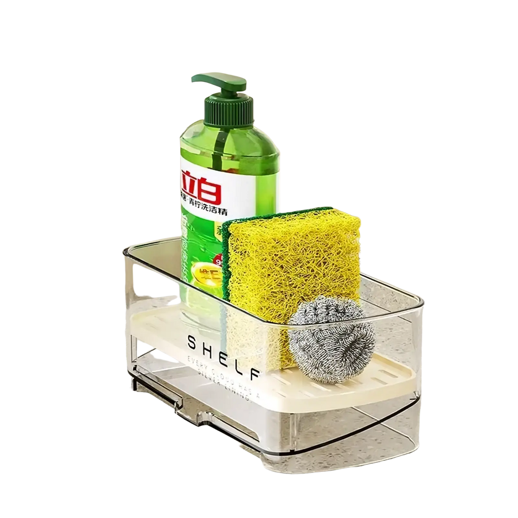 Clear plastic kitchen sink organizer with beige base holding green dish soap bottle and cleaning sponges