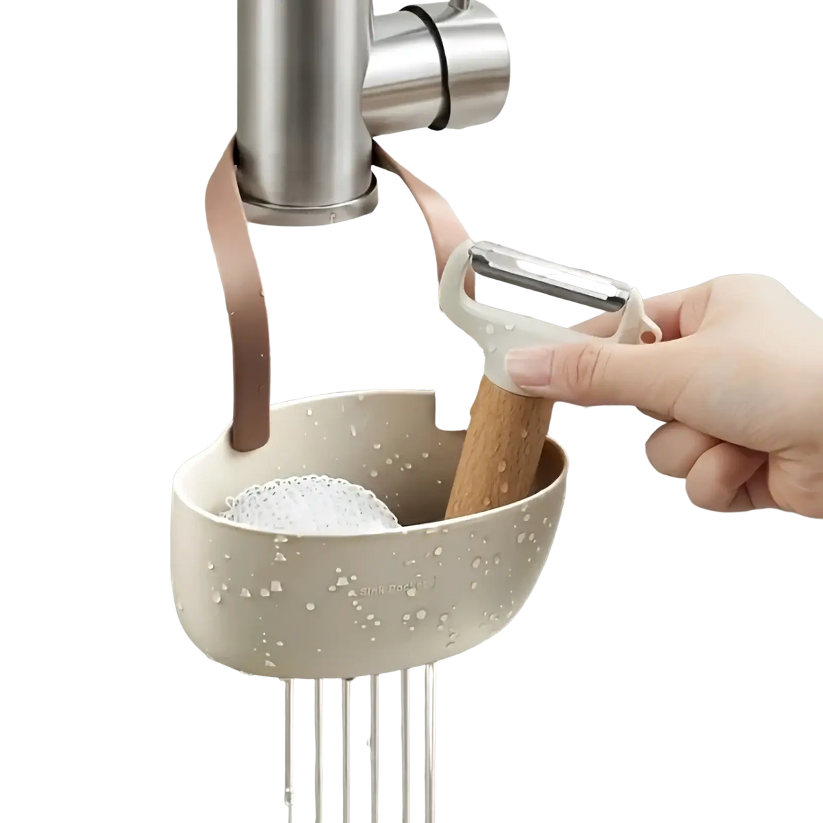 Beige plastic kitchen sink organizer hanging sponge caddy with soft pink strap holding a sponge and peeler