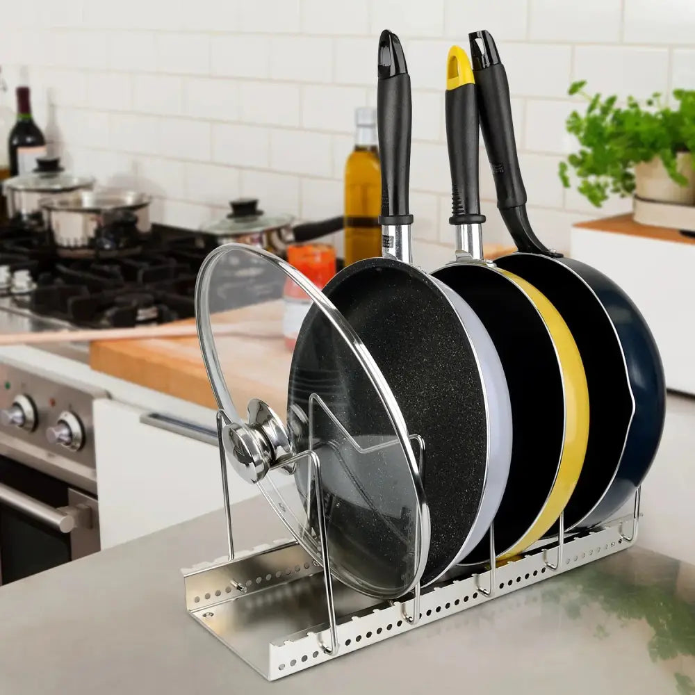 Adjustable stainless steel pot and pan organizer rack holding non-stick frying pans with black yellow and navy handles