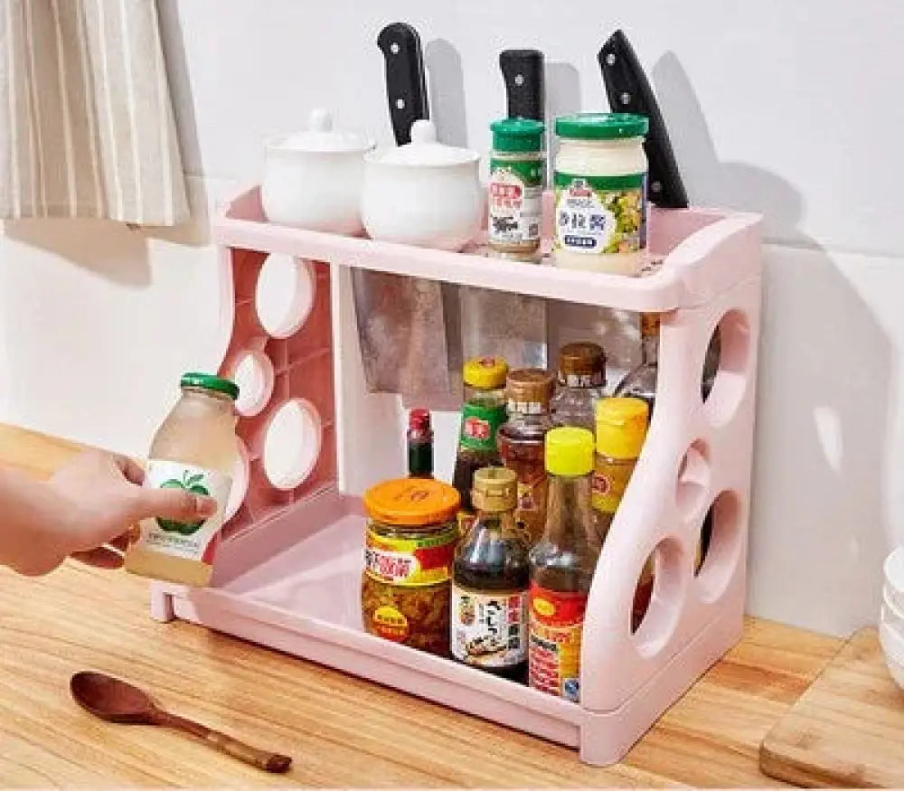 Pink plastic multilayer two tier kitchen spice and utensil organizer rack with circular cutouts and integrated knife holders