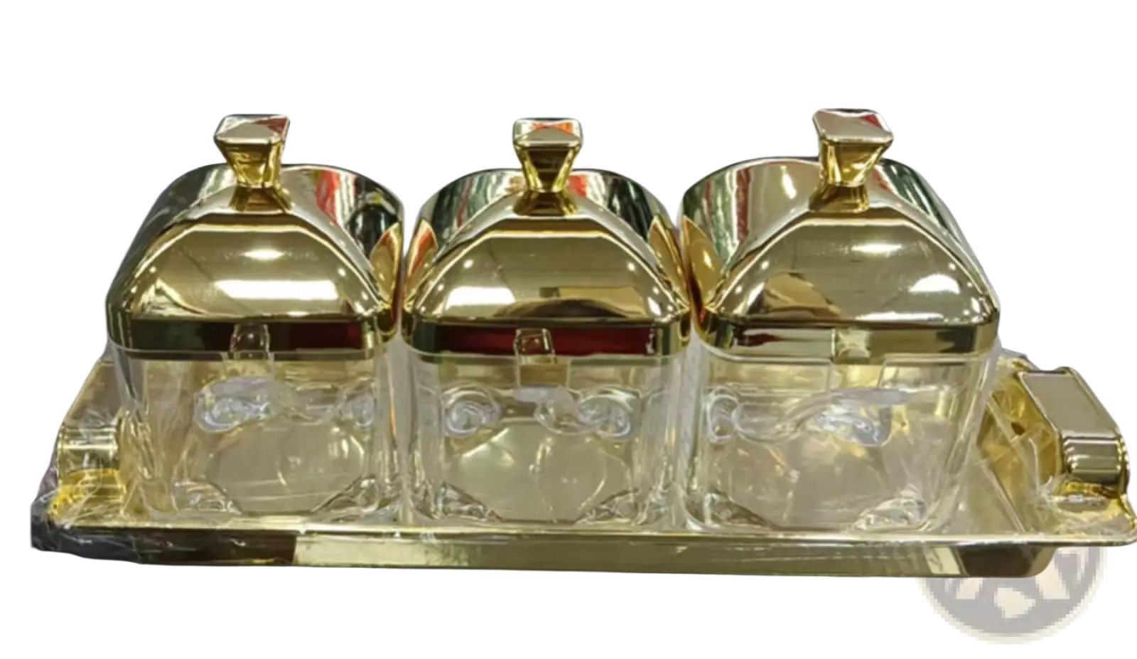 Set of three gold-finished glass condiment jars with decorative lids on a matching golden tray for kitchenware use